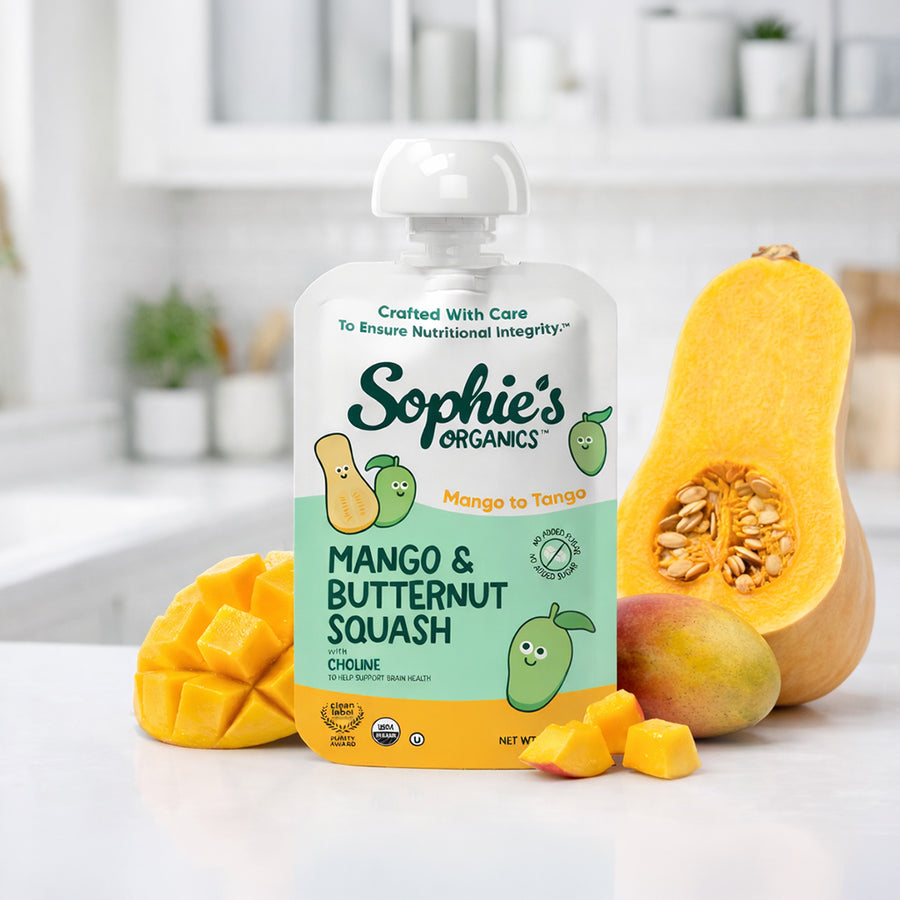 Sophie's Organics Mango to Tango organic baby food pouch with mango and butternut squash in a kitchen.