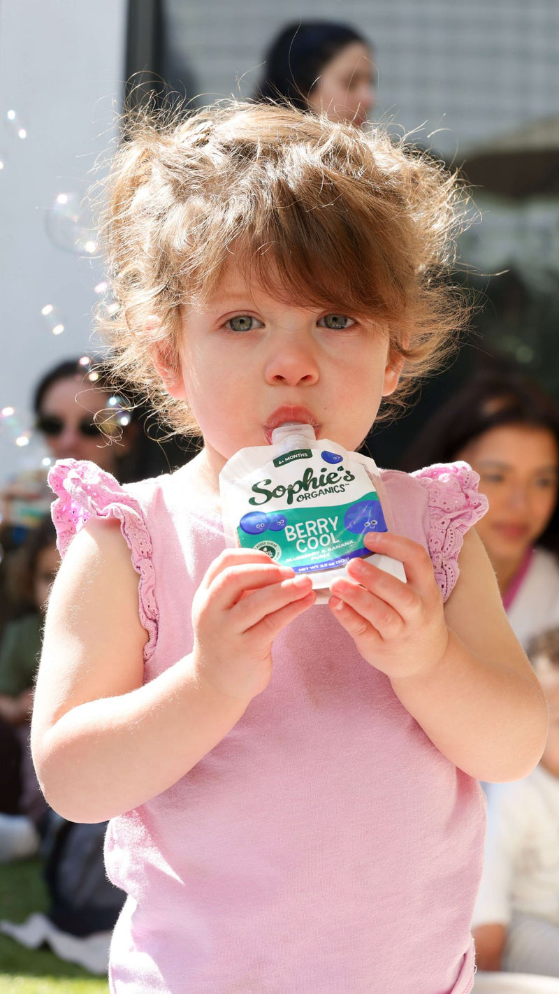 Sophie eating a pouch
