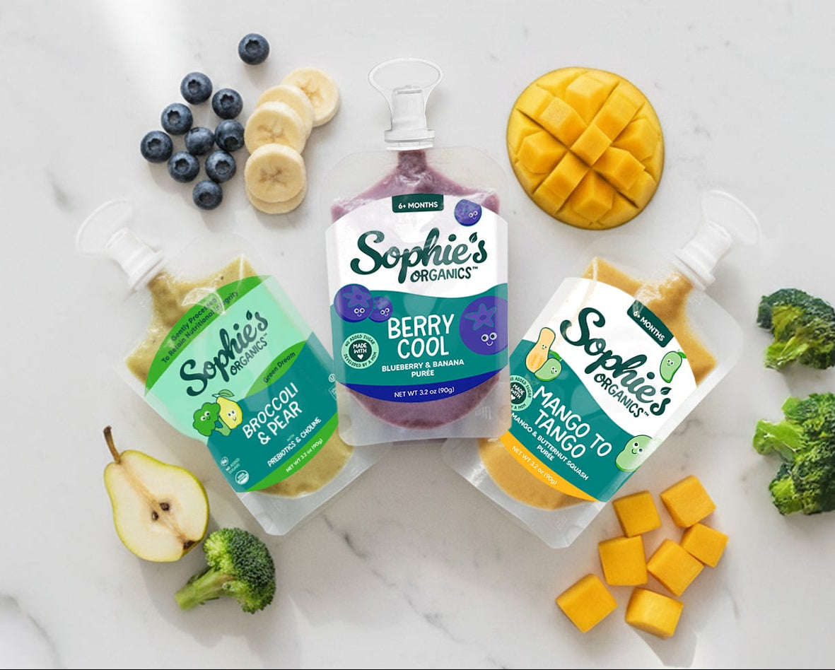 Sophie's puree products with fruits and vegetables on a marble surface